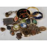 A collection of assorted costume jewellery to include brooches, powder compacts, chains etc.