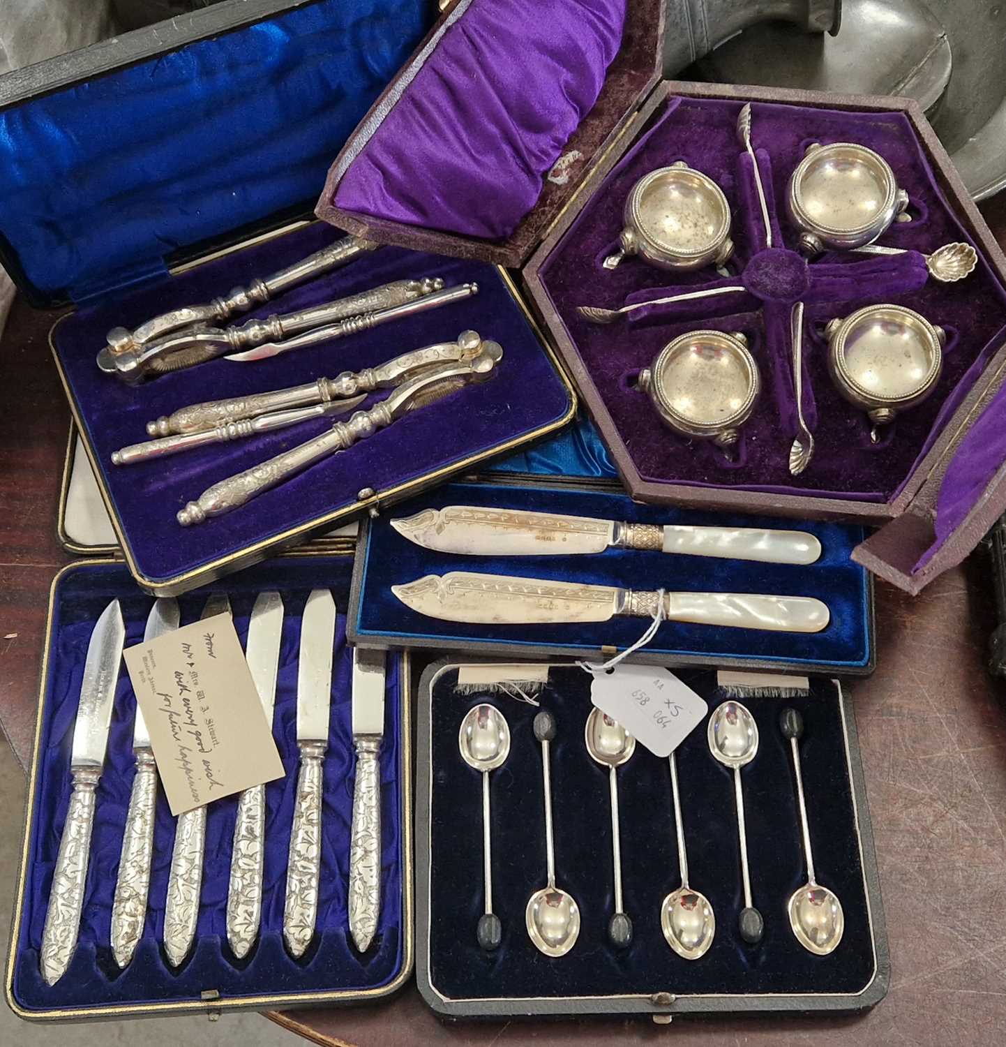 Five cased sets of EP wares comprising six coffee bean terminal teaspoons, a nut crack set, six