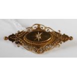 A late 19th century 15CT gold brooch centered with a small diamond, gross weight 6.4 grams.