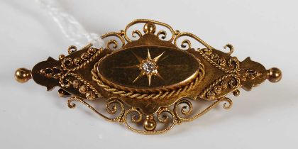 A late 19th century 15CT gold brooch centered with a small diamond, gross weight 6.4 grams.