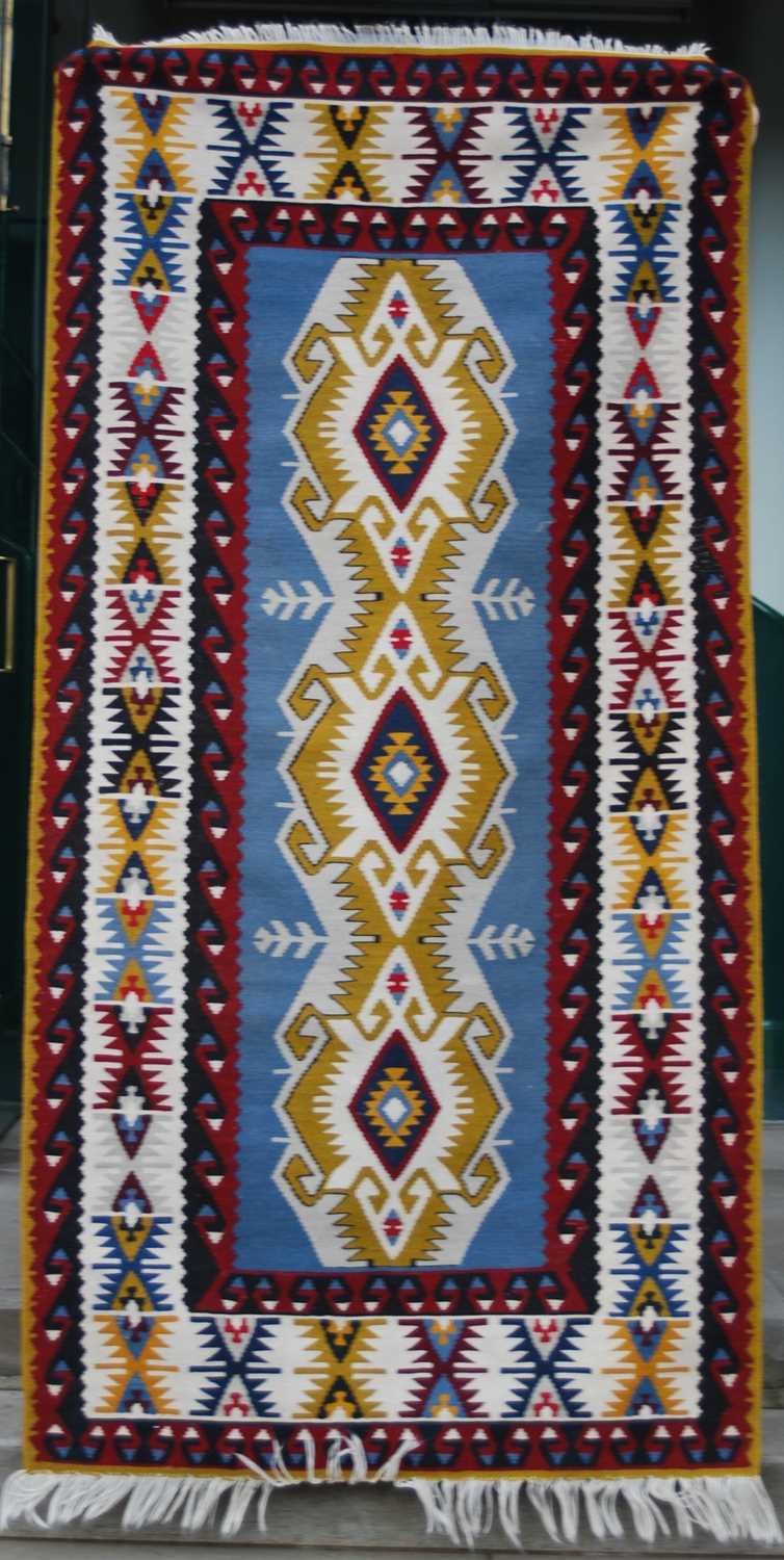 A Kelim rug, 20th century, the rectangular blue ground centred with a row of three lozenge shaped - Image 3 of 5