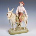 A Royal Dux porcelain figure of a boy riding a donkey, impressed marks, no.1989, 376cm high.