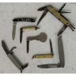 A collection of seven assorted vintage pocketknives to include one in the form of a key.