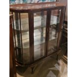 A vintage mahogany glazed display cabinet, the glazed double doors opening to an interior with