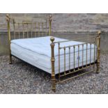 A Victorian style double brass bed, the headboard and footboard with turned finials and vertical