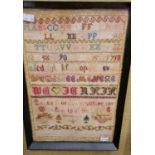 A Victorian needlework sampler, worked in coloured threads by Annie Clyne, aged 12 1892, framed