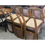 A set of six Victorian oak dining chairs with upholstered backs and seats with brass studded