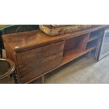 A rosewood side cabinet with two open recesses and a cupboard door, 183cm wide.