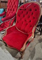 A Victorian mahogany parlour chair with red button down velvet upholstered back arms and stuff