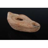 An antique pottery oil lamp, possibly Roman, 9cm long.