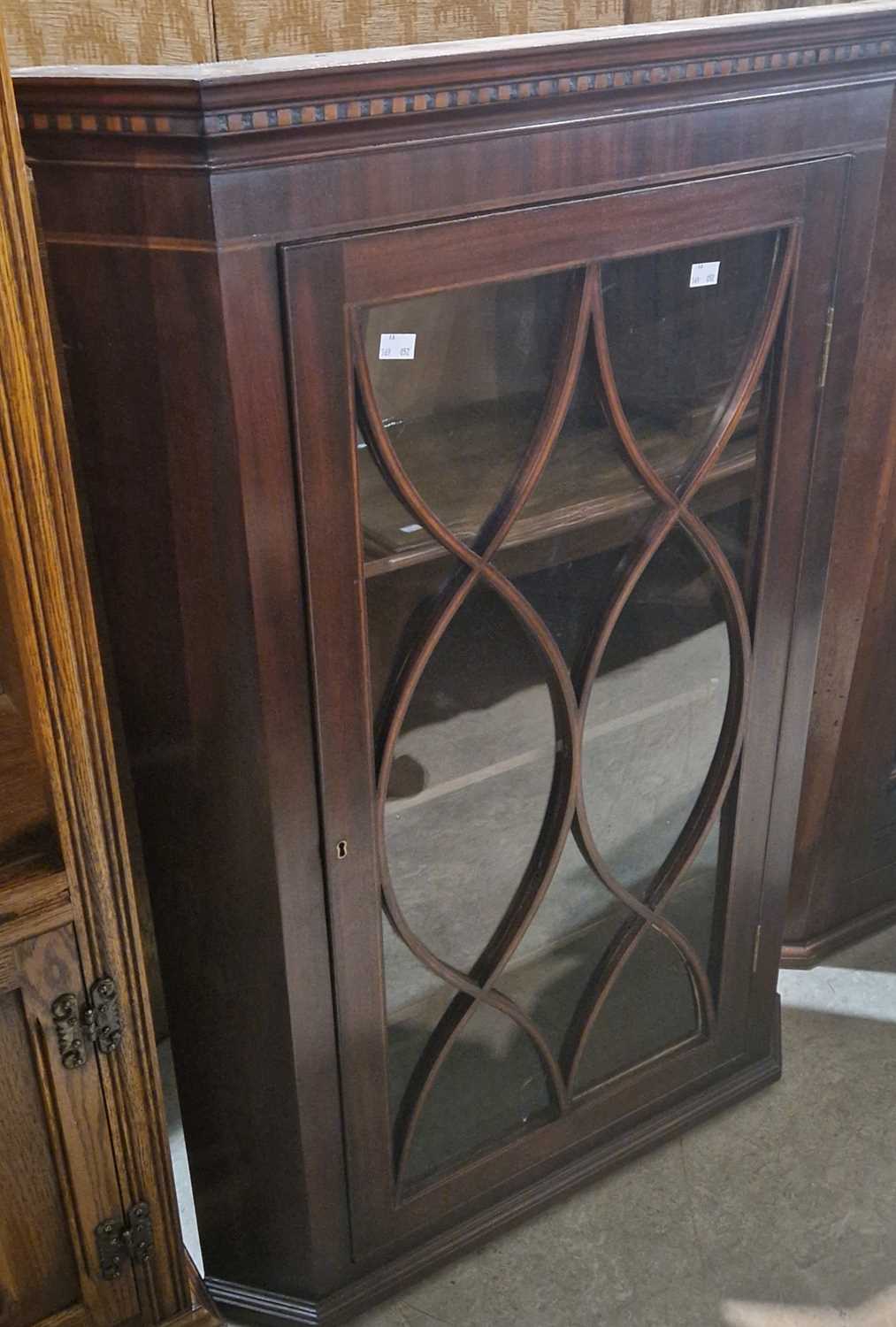 A Georgian mahogany corner cupboard with astragal glazed door opening to three fitted shelves, 109cm