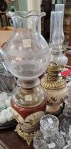Two late 19th / early 20th century brass, glass and ceramic paraffin lamps.