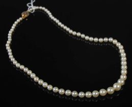 An 18ct gold mounted single strand graduated pearl necklace.
