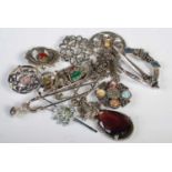 A collection of assorted Scottish white metal brooches.