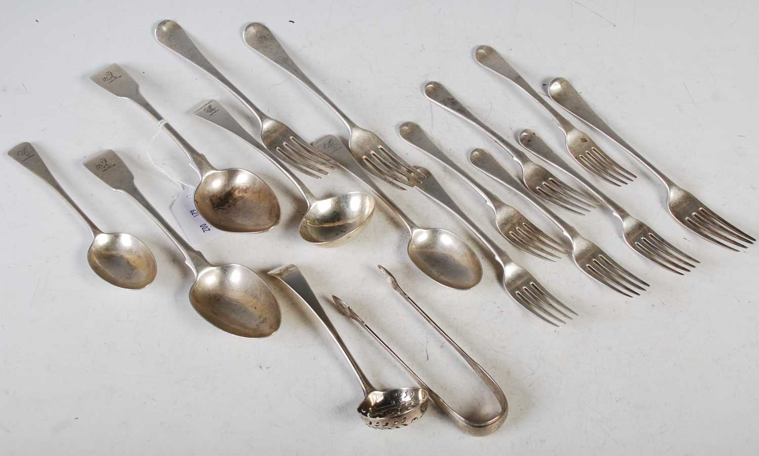 A collection of assorted silver flatware comprising three table forks, six dessert forks, two