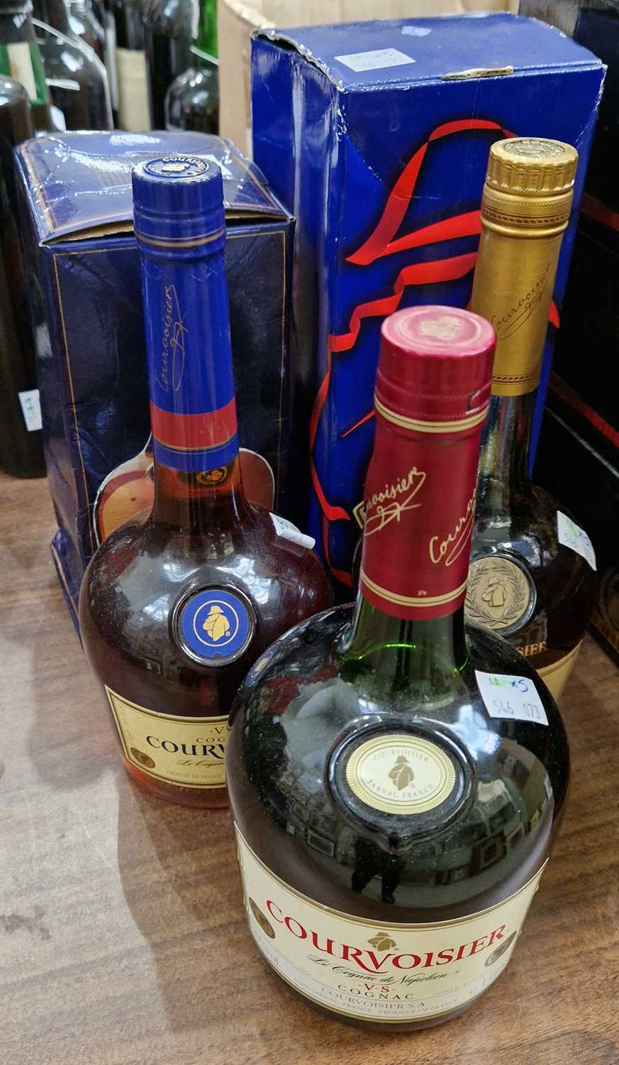 Five bottles to include a boxed Courvoisier V.S. Cognac, 70cl, A boxed Courvoisier V.S.O.P fine