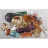 A bag of assorted loose semi-precious gemstones.