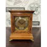 A late 19th / early 20th century oak cased table/ bracket clock, the case with brass carry handle,