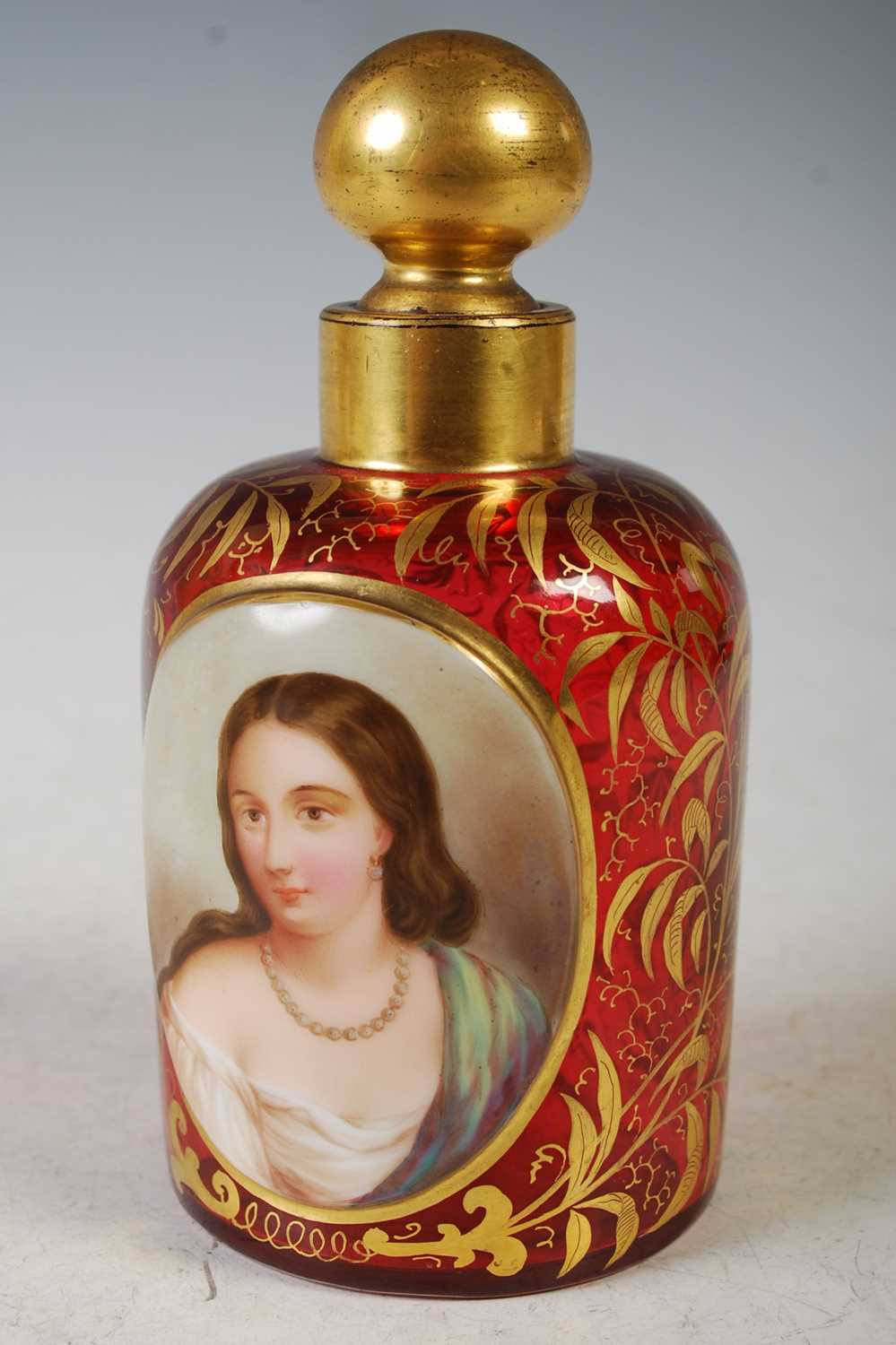 A late 19th century bohemian ruby glass and white overlaid glass toilet bottle and stopper, the