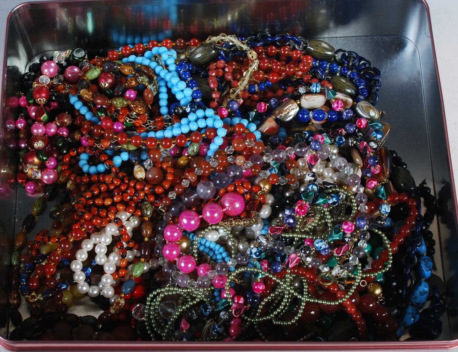A box of assorted costume jewellery, necklaces etc.