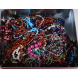 A box of assorted costume jewellery, necklaces etc.