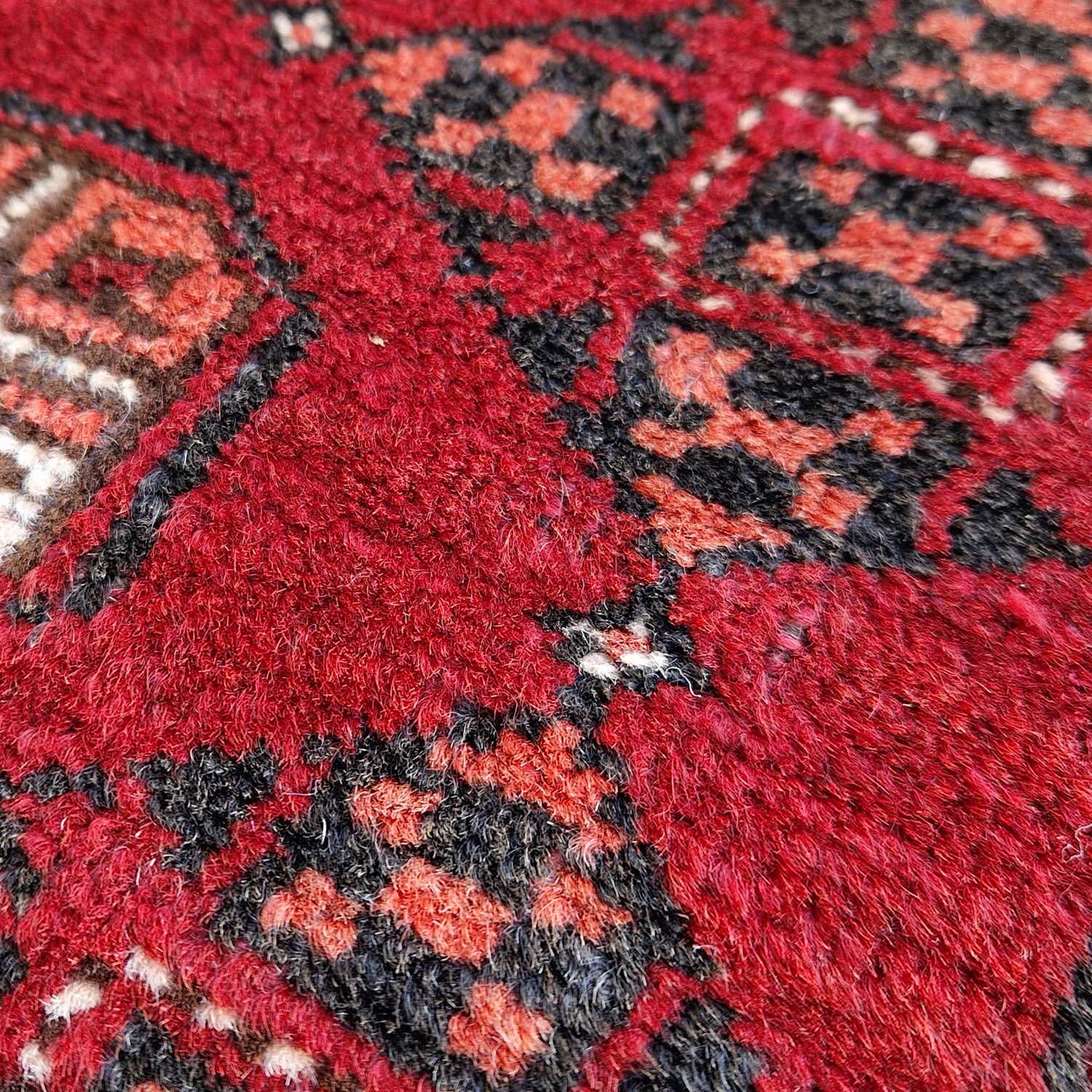 A Persian Tekke rug, the rectangular madder ground centred with two rows of twenty octagonal - Image 4 of 4