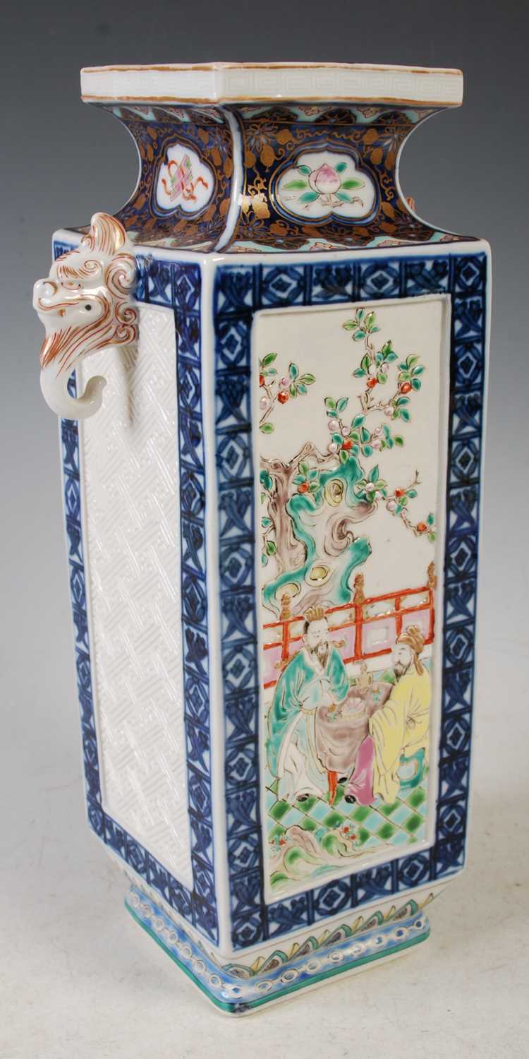 A Chinese porcelain square shaped vase, decorated in shallow relief with two scholars sitting at a