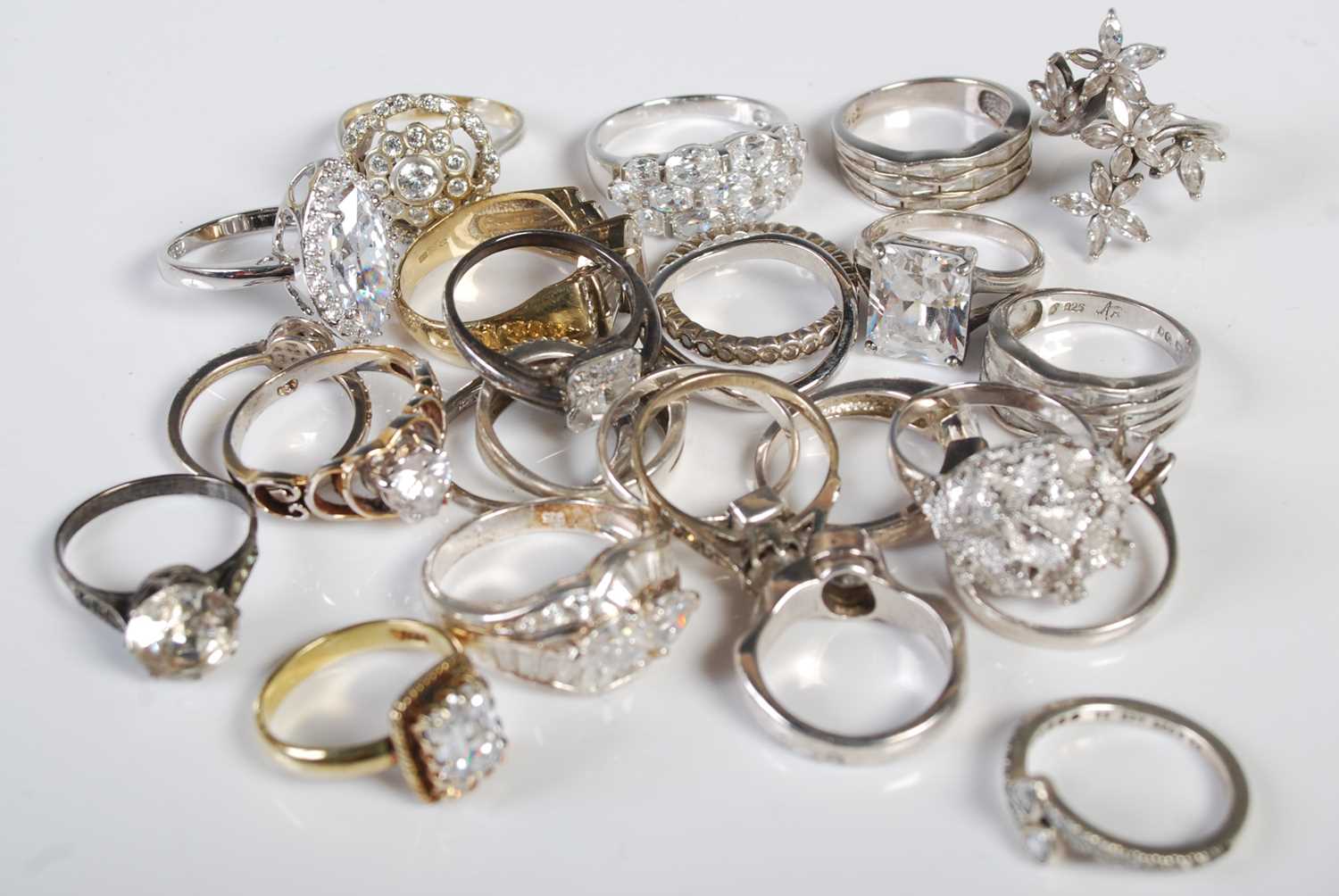 A collection of twenty-five assorted silver white and yellow metal dress rings.