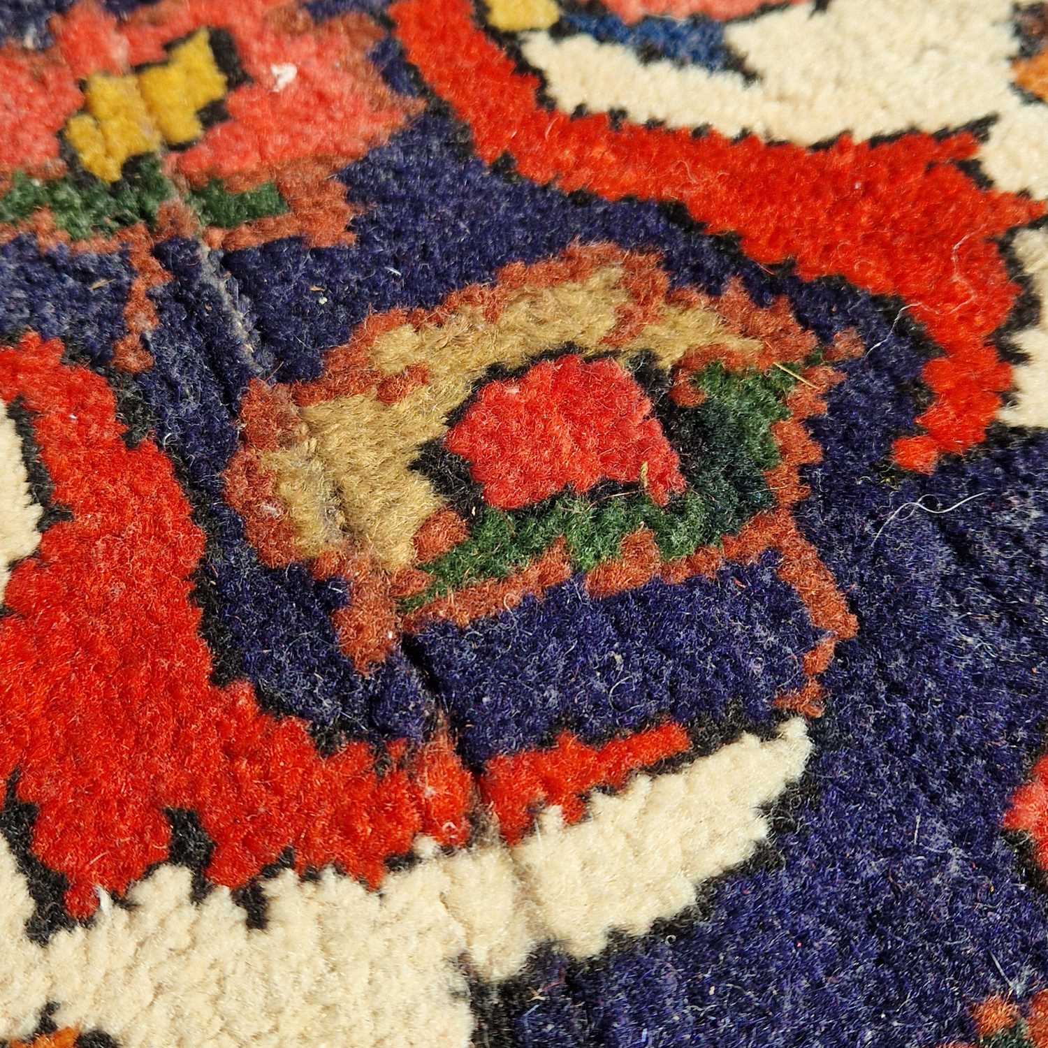 A Persian rug, 20th century, the rectangular madder ground centered with a blue ground oval - Image 5 of 5