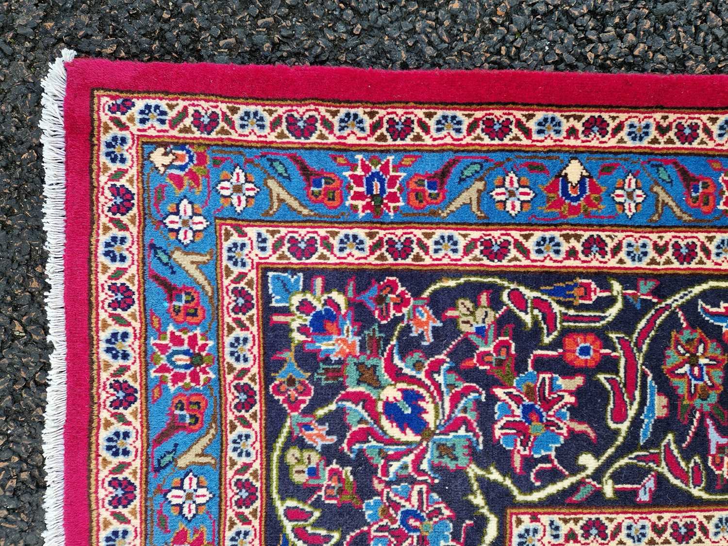 A Persian Mashad carpet, 20th century, the rectangular magenta ground centred with a blue lozenge - Image 2 of 5