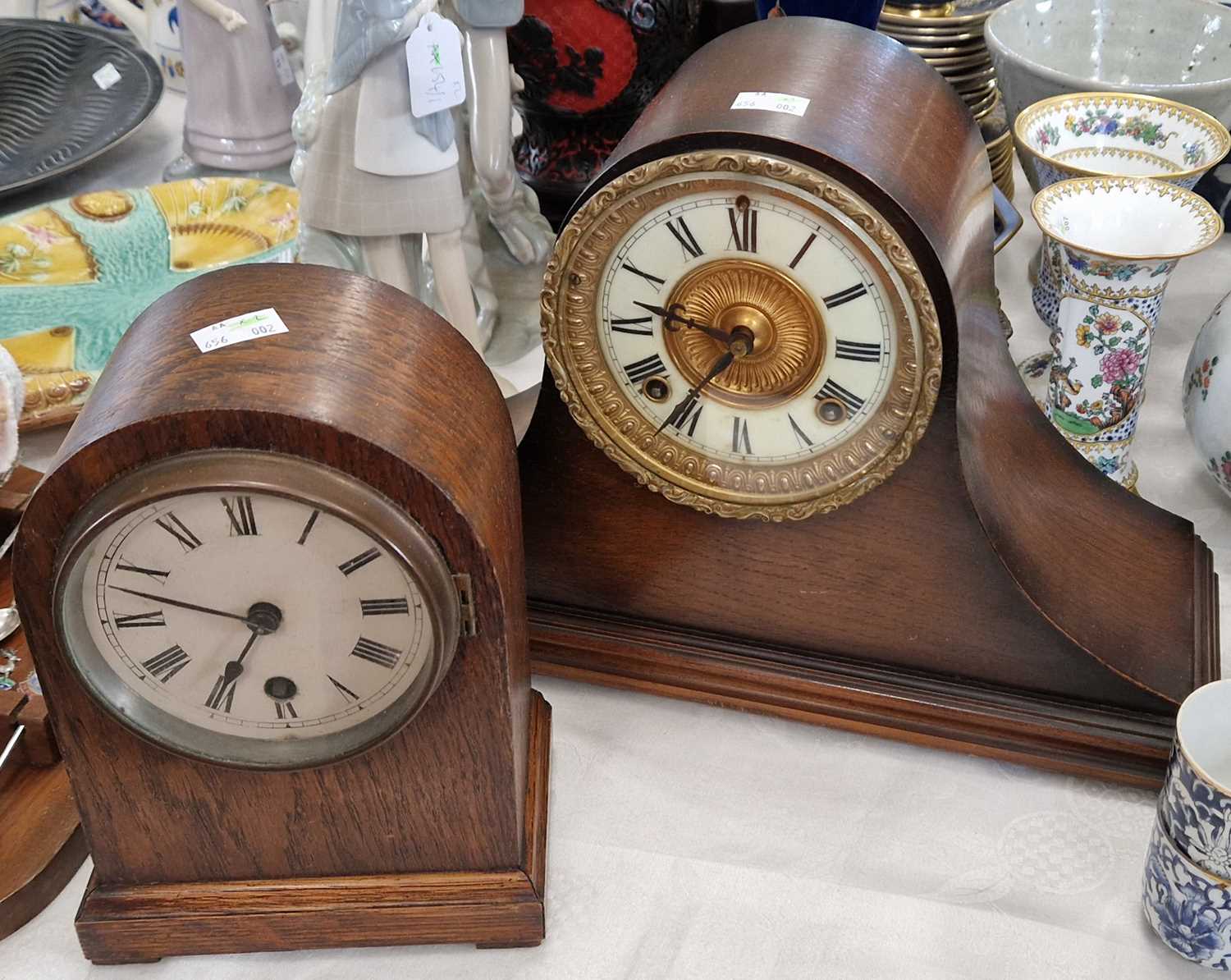 An early 20th Century Ansonia oak cased mantle clock, with roman numeral dial, and twin train