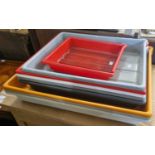 A collection of nine assorted vintage coloured plastic photography developing trays, the largest