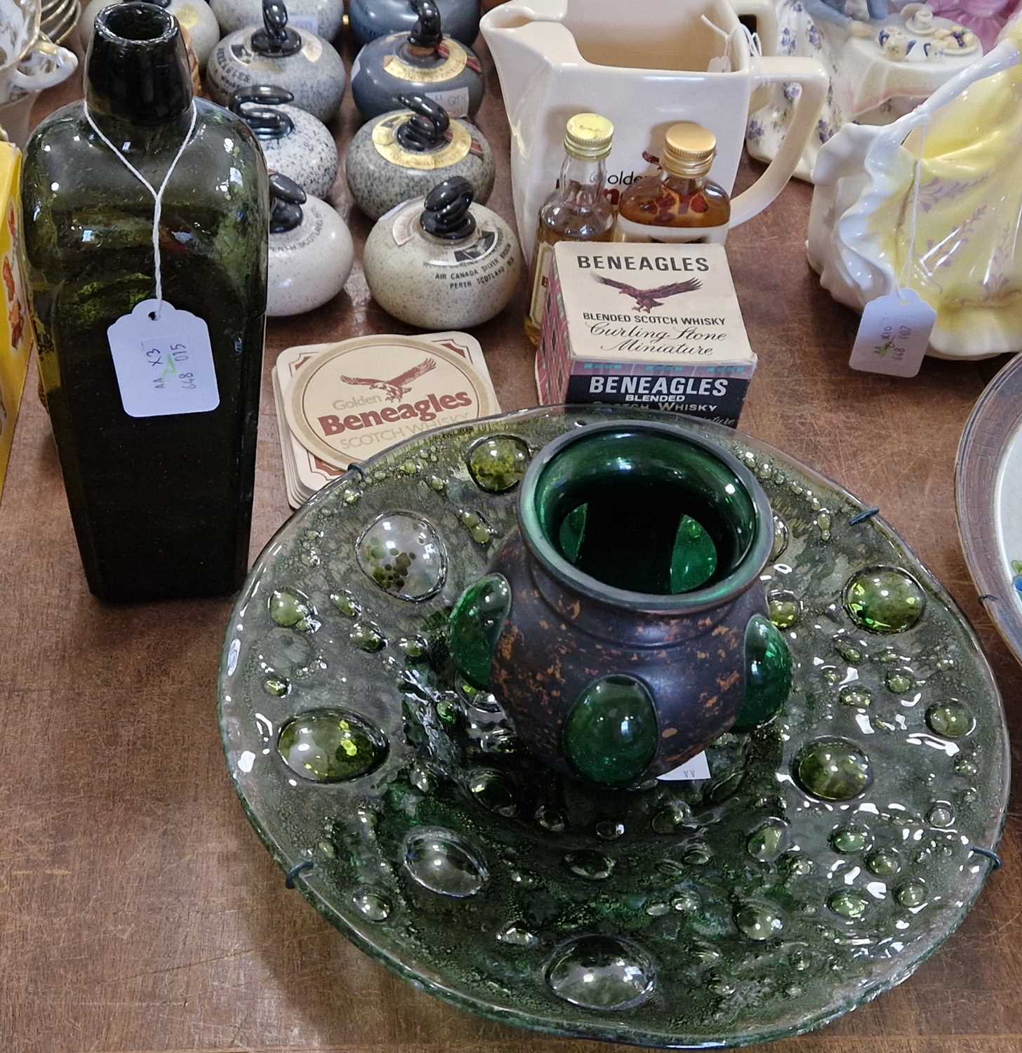 An antique green glass bottle, 24cm high; together with a green art glass dish of bubble design, and