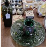 An antique green glass bottle, 24cm high; together with a green art glass dish of bubble design, and