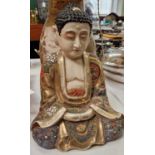 An early 20th century Japanese Satsuma buddha figure, the underside with painted marks, 24cm high.