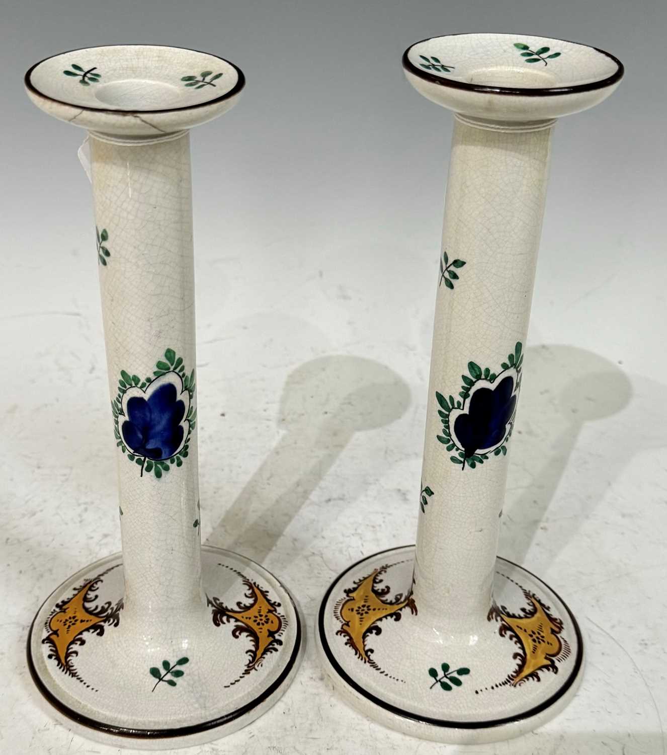 A pair of late 19th Century Wemyss 'Turkey' pattern Scottish pottery candlesticks, with impressed