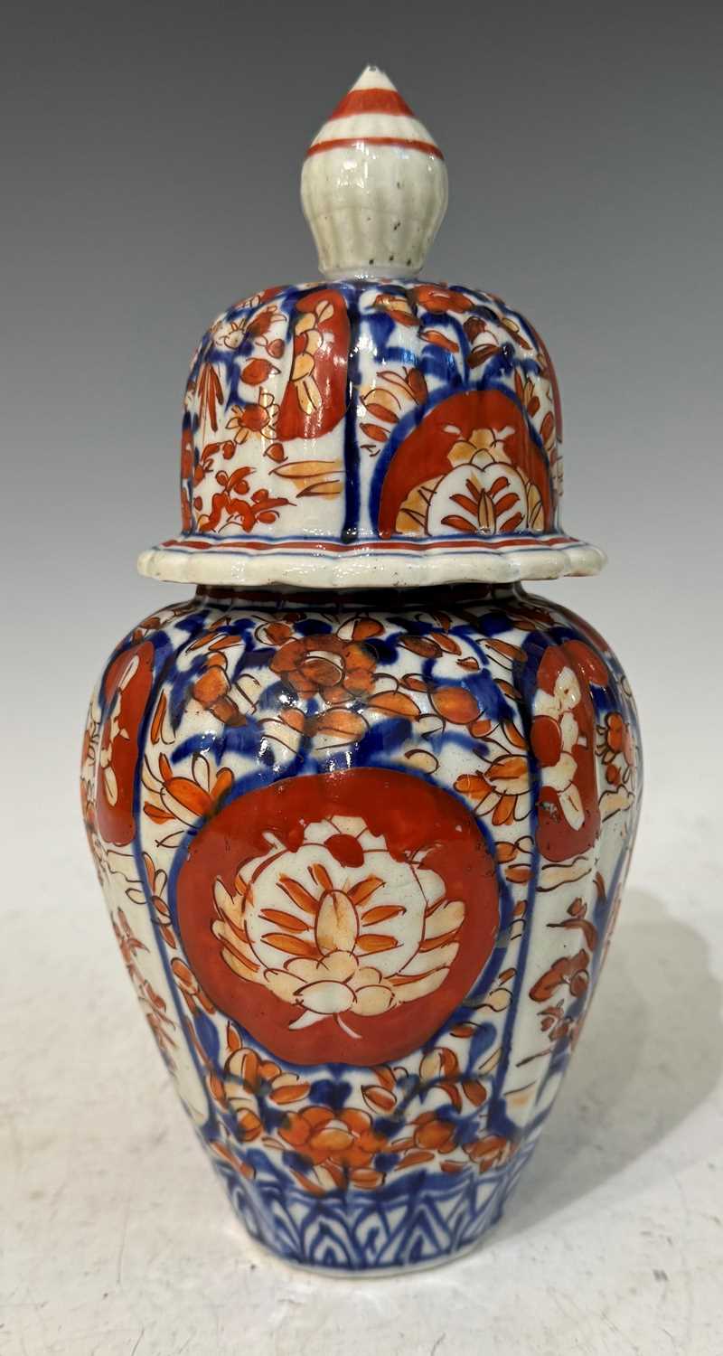 An early 20th Century Japanese porcelain Imari jar and cover of ribbed ovoid form, 25cm high