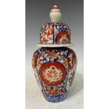 An early 20th Century Japanese porcelain Imari jar and cover of ribbed ovoid form, 25cm high