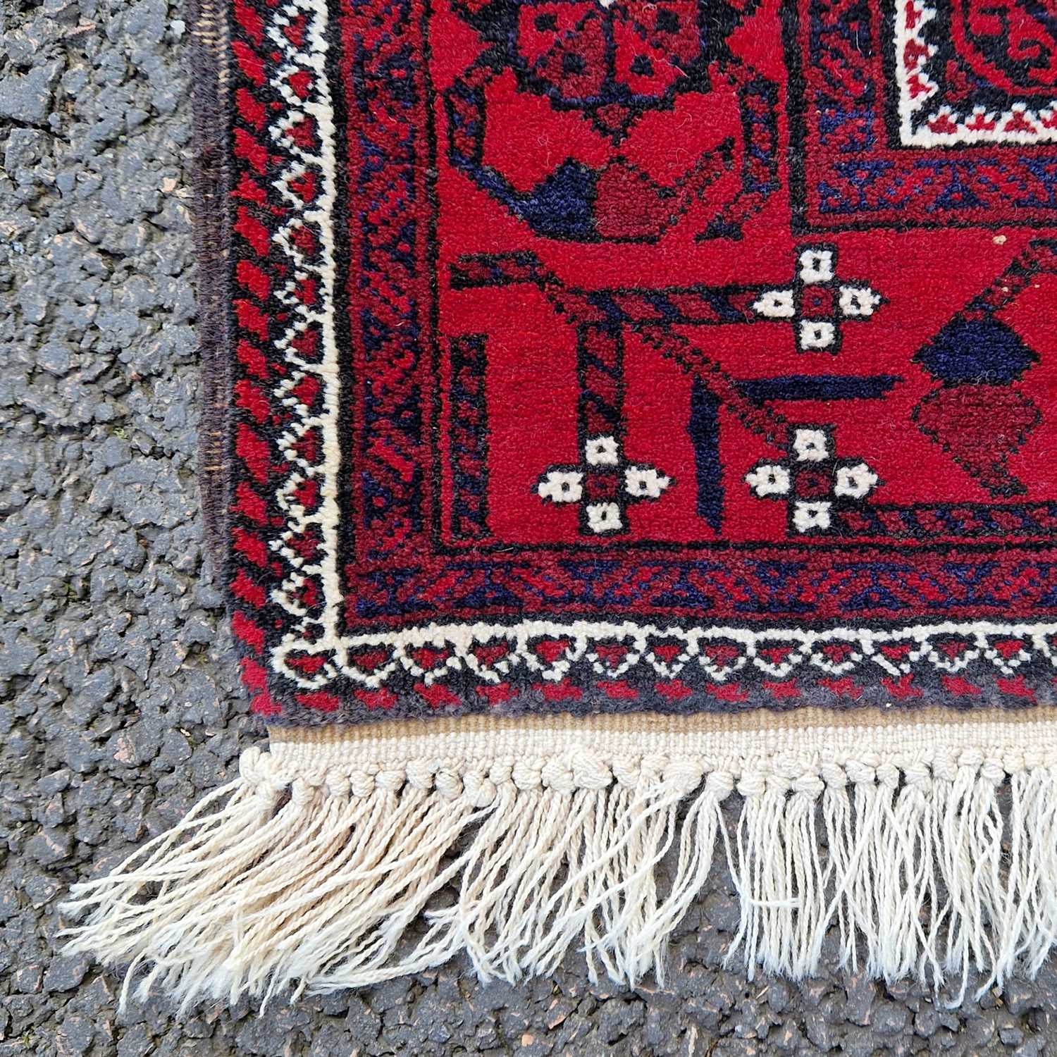 An Iranian madder ground rug, the rectangular field decorated with all over design of octagonal - Image 3 of 4