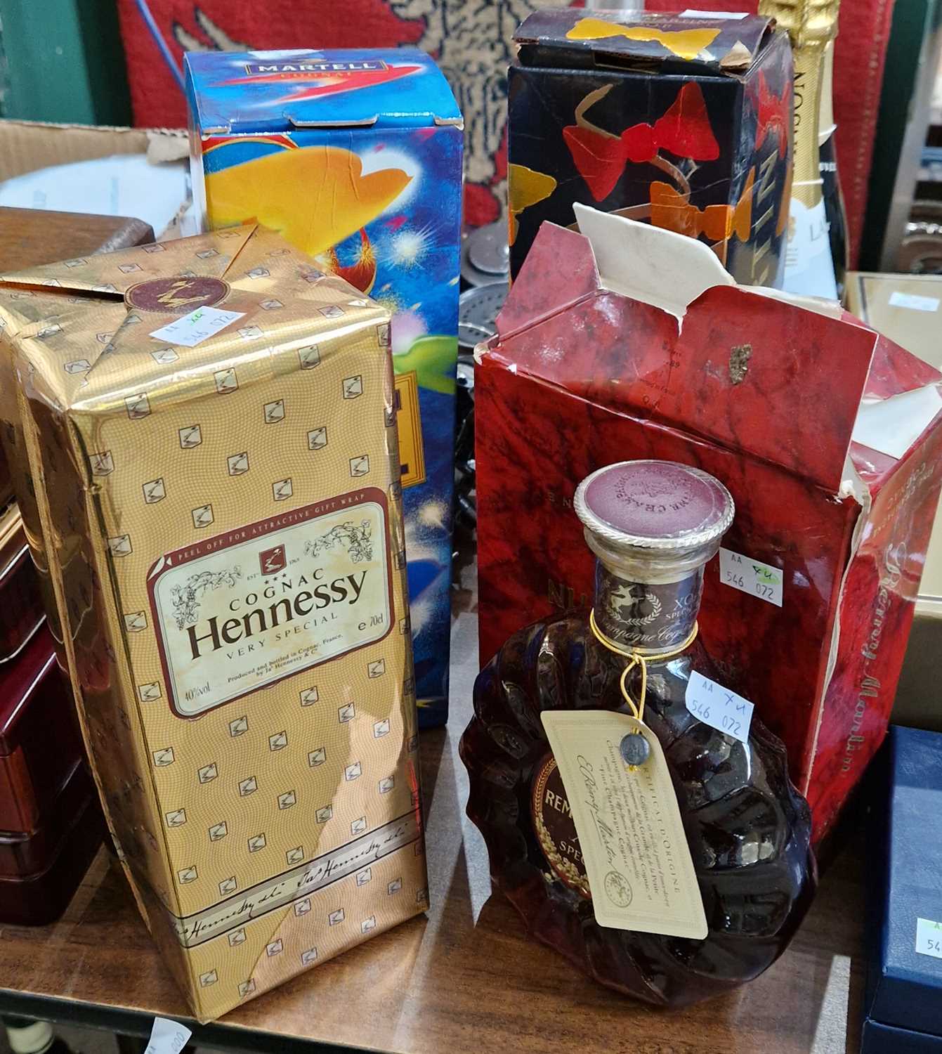 Four bottles to include a Remy Martin XO special fine champagne cognac in original box, 70cl, a Remy