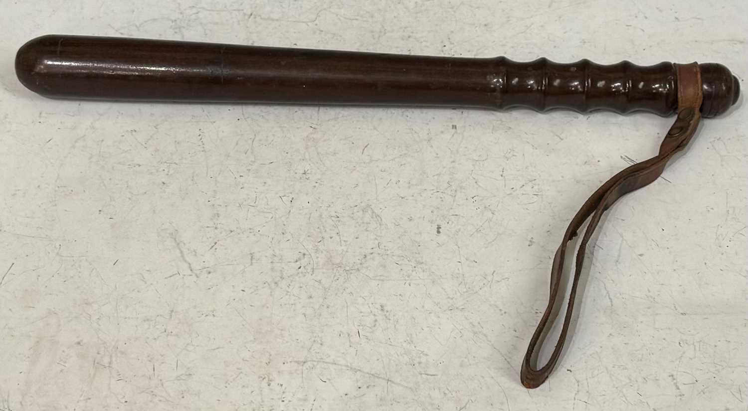 An Antique turned wooden Truncheon / Baton, with leather wrist strap, 39.5cm long.
