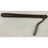 An Antique turned wooden Truncheon / Baton, with leather wrist strap, 39.5cm long.