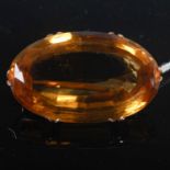 A yellow metal mounted oval facet cut citrine brooch, overall 39.8 mm wide.