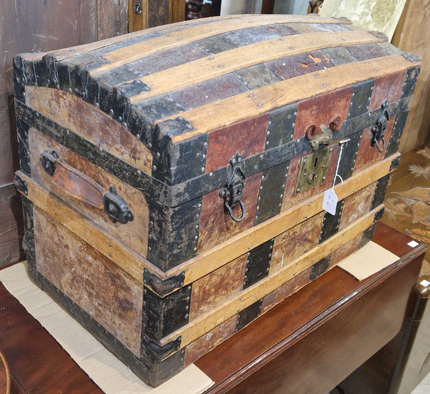 A vintage wood, leather and metal bound dome top trunk, 71cm wide.