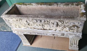 A composite stone garden planter, the rectangular planter moulded in relief with urn, fruit, flowers