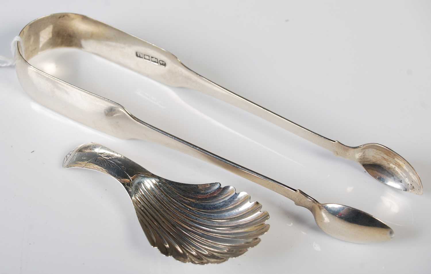 A William IV silver caddy spoon, Birmingham, 1832, makers mark T & P, together with a pair of George