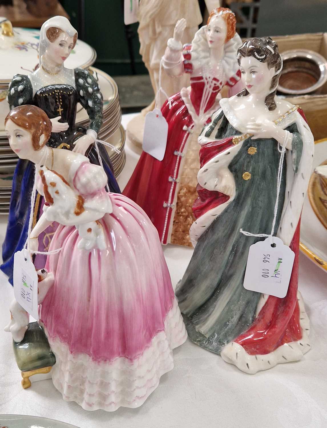 Four Royal Doulton lady figures from the Queens of the Realm series, comprising Queen Victoria