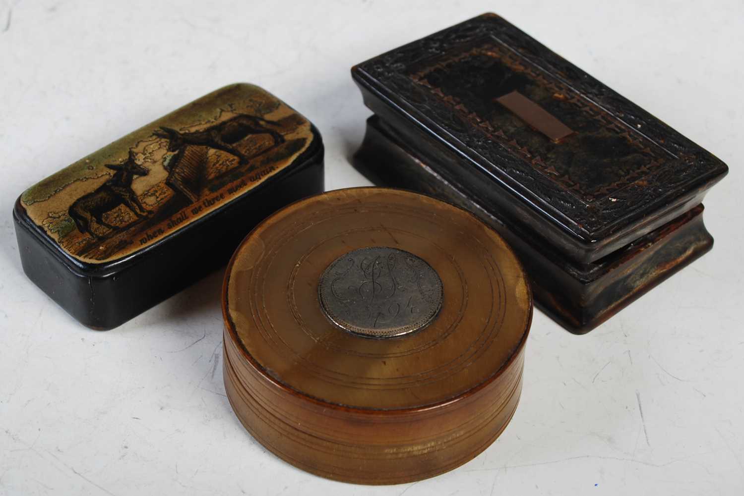 Three antique snuff boxes to include a circular white metal mounted horn example, a rectangular