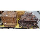 A late 19th century Black Forest carved wood casket, decorated in relief with flowers and birds,