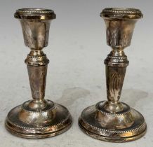 A pair of Birmingham silver candlesticks, 1977, filled, 11cm high